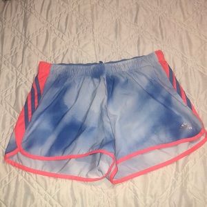 Adidas blue and white shorts with neon coral